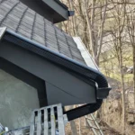 Black gutter installation along roof edge on Dayton Ohio home with architectural shingles