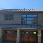 Gutter installation on luxury home in Indian Hill Ohio with metal roof and stone columns