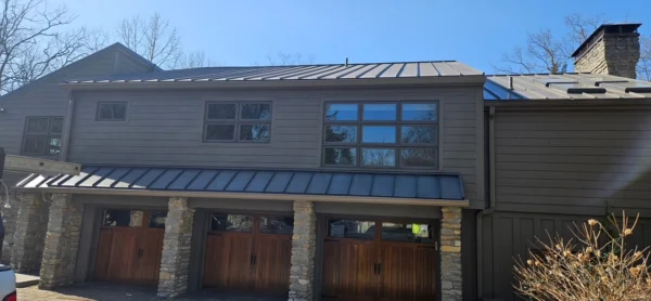 Gutter installation on luxury home in Indian Hill Ohio with metal roof and stone columns