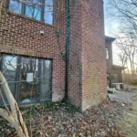 Downspout installation on brick home in Dayton Ohio directing water away from foundation