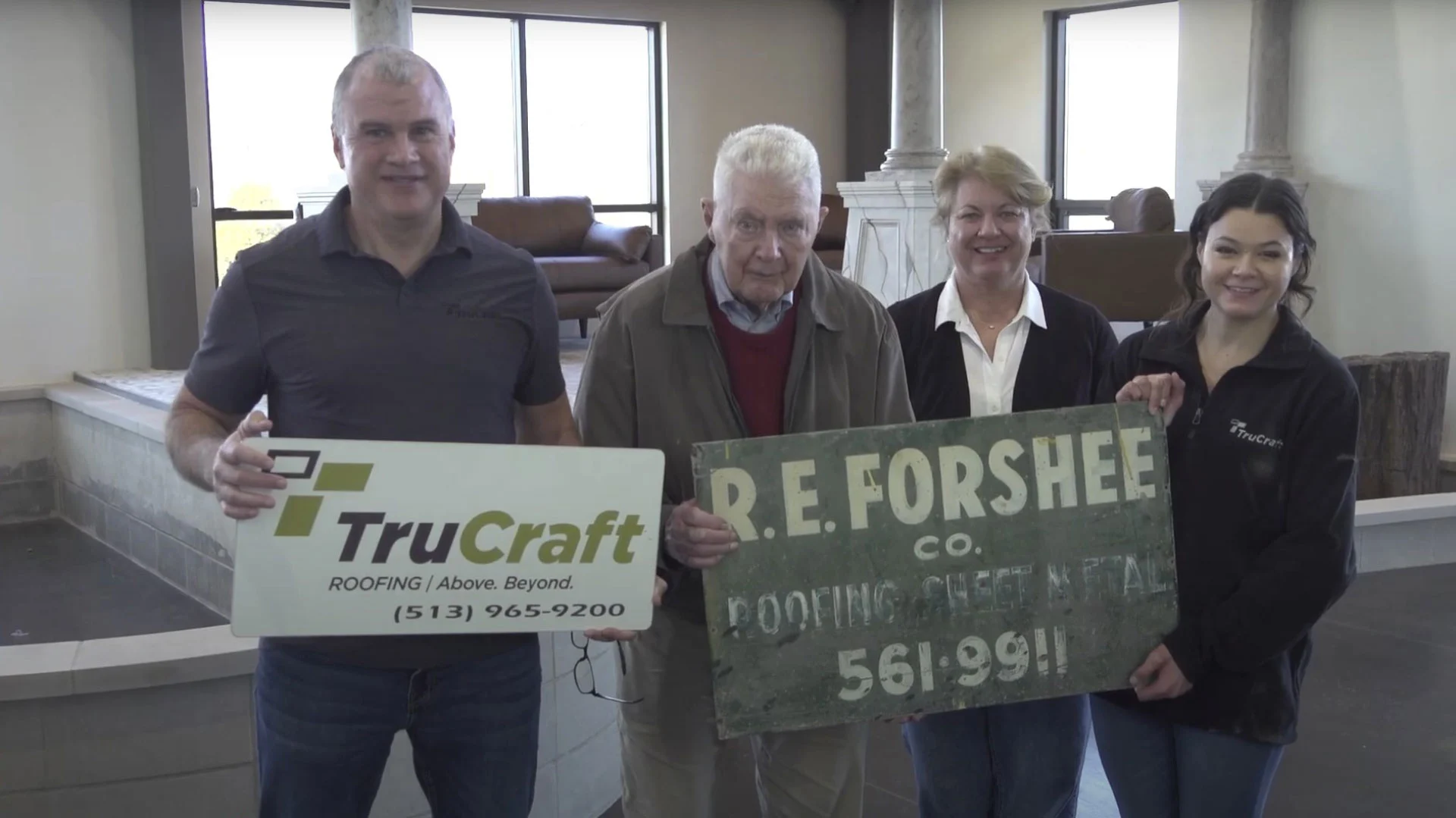 TruCraft Roofing owner Rod Sparks and family holding TruCraft and R.E. Forshee Co. signs, honoring the family’s roofing legacy in Cincinnati, Ohio.