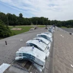 Roofing materials staged on roof during school roof replacement project in Batavia Ohio
