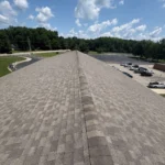 School roof replacement completed by TruCraft Roofing in Batavia Ohio showing new shingle installation along roof ridge