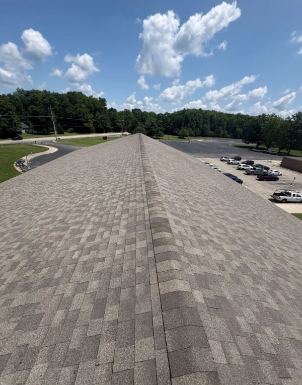 School roof replacement completed by TruCraft Roofing in Batavia Ohio showing new shingle installation along roof ridge
