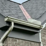 Roof valley with exposed metal flashing and worn shingles on residential home in Cincinnati