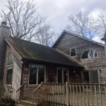 Aging roof with moss growth and worn shingles on Cincinnati home