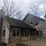 Aging roof before roof replacement project in Loveland Ohio on rustic cedar home