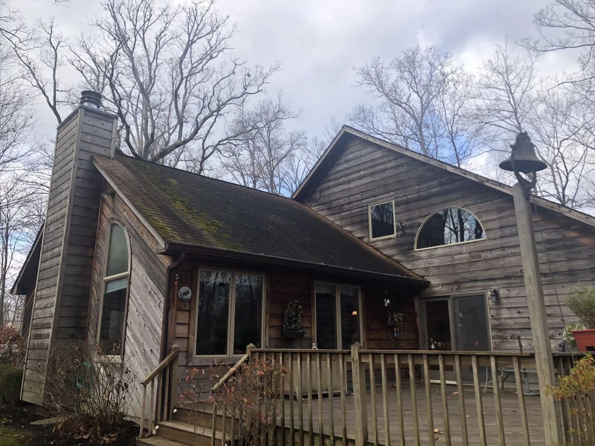 Aging roof before roof replacement project in Loveland Ohio on rustic cedar home