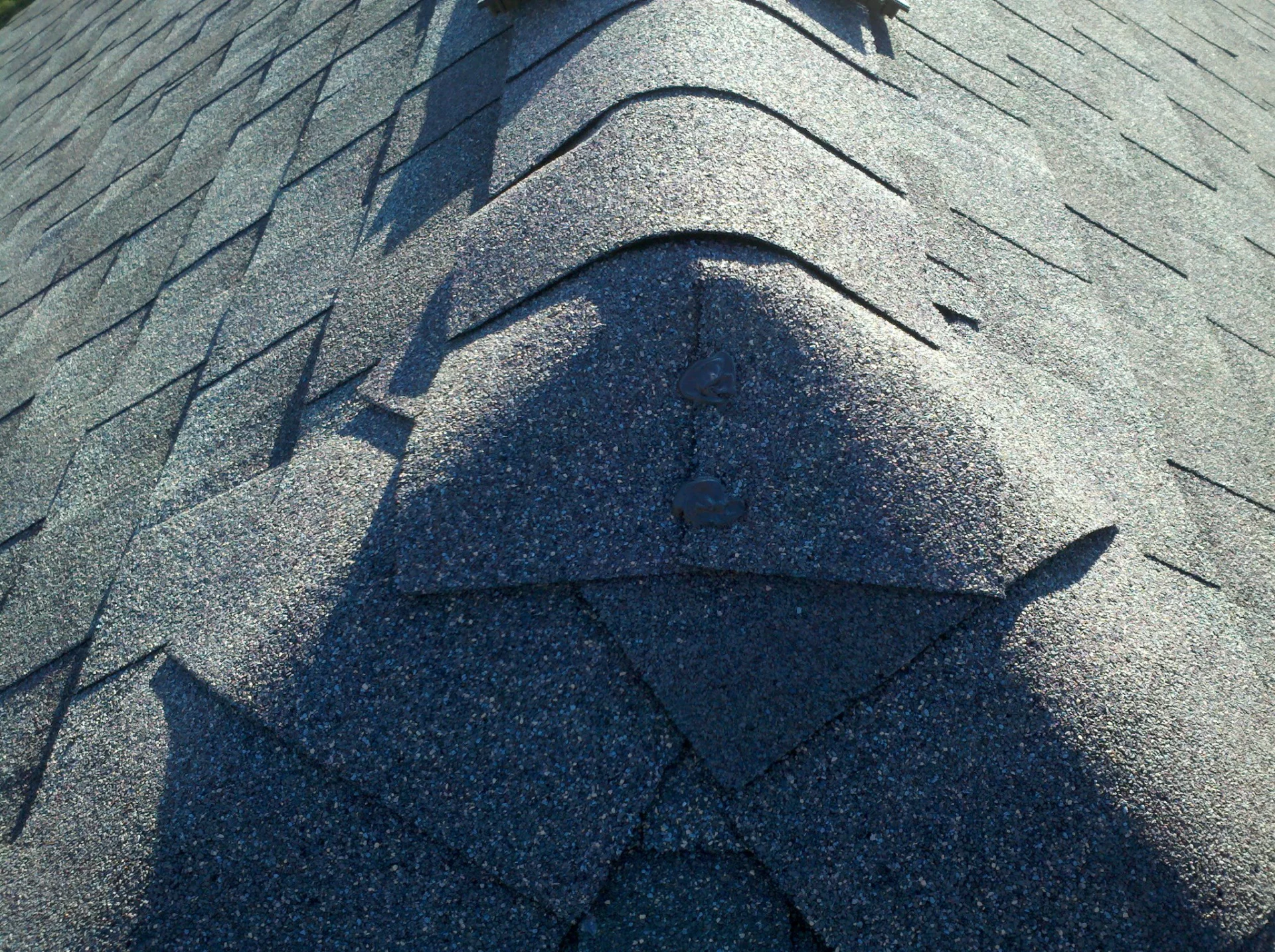Ridge vent installation on asphalt shingle roof in Cincinnati