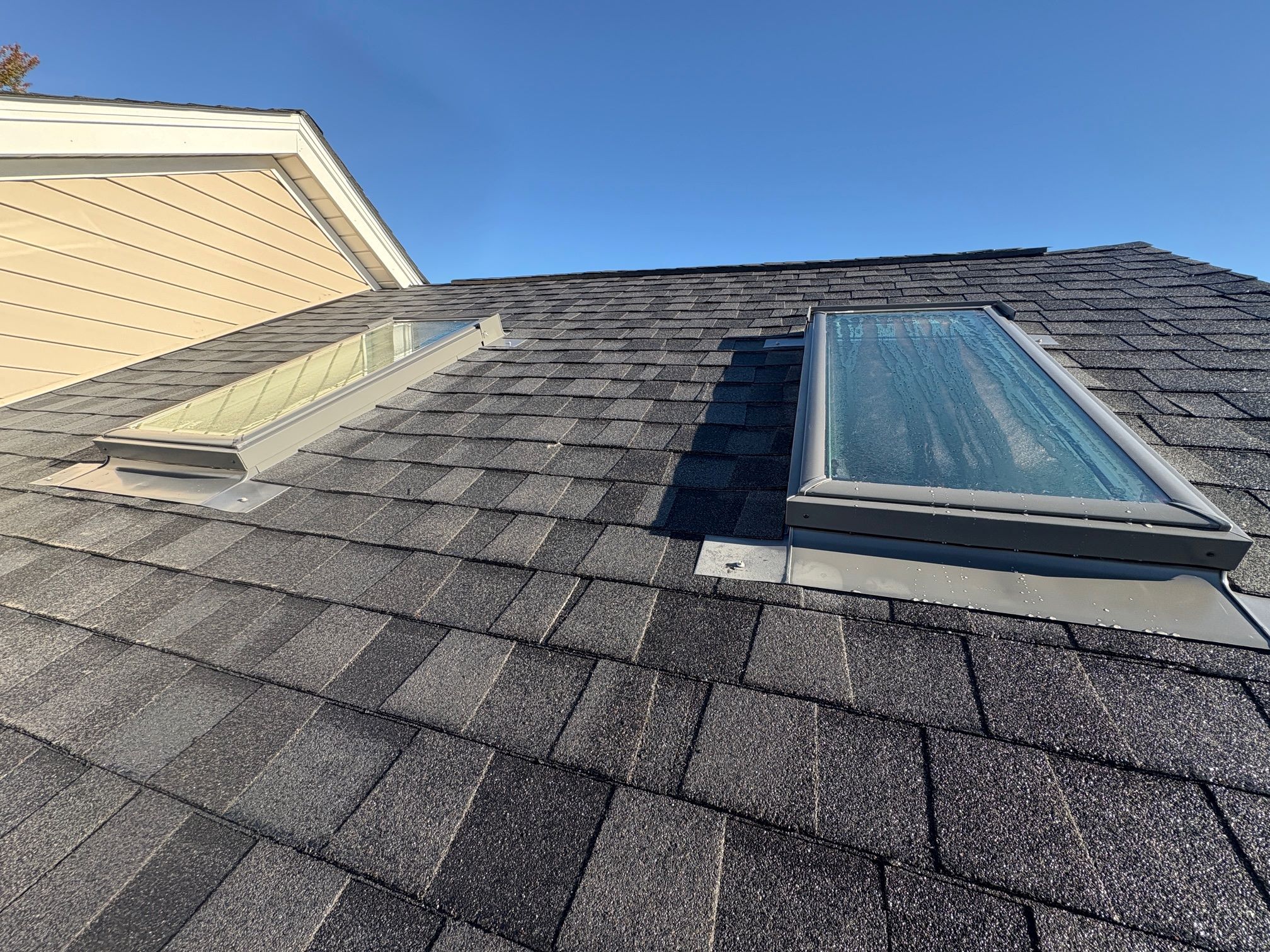 New skylights installed on an asphalt shingle roof by a roofing contractor in Loveland, Ohio.