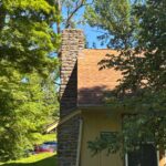 Stone chimney at the Guest House following chimney waterproofing as part of a Milford roof repair.