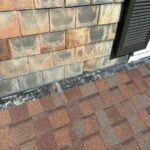 Close-up of CertainTeed Landmark PRO® HeatherBlend shingles and repaired flashing during a Milford roof repair.