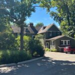 Roof repair at Krippendorf Lodge showing repaired shingles and membrane areas during a Milford roof repair.
