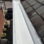 Completed Bellevue box gutter restoration with GE Enduris silicone coating protecting the historic built-in gutter system.