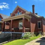 Historic brick home in Bellevue, Kentucky that received box gutter restoration, slate roof repairs, and new metal flashing by TruCraft Exteriors.