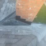 Completed roof cricket and flashing around a brick chimney on a Maineville home.